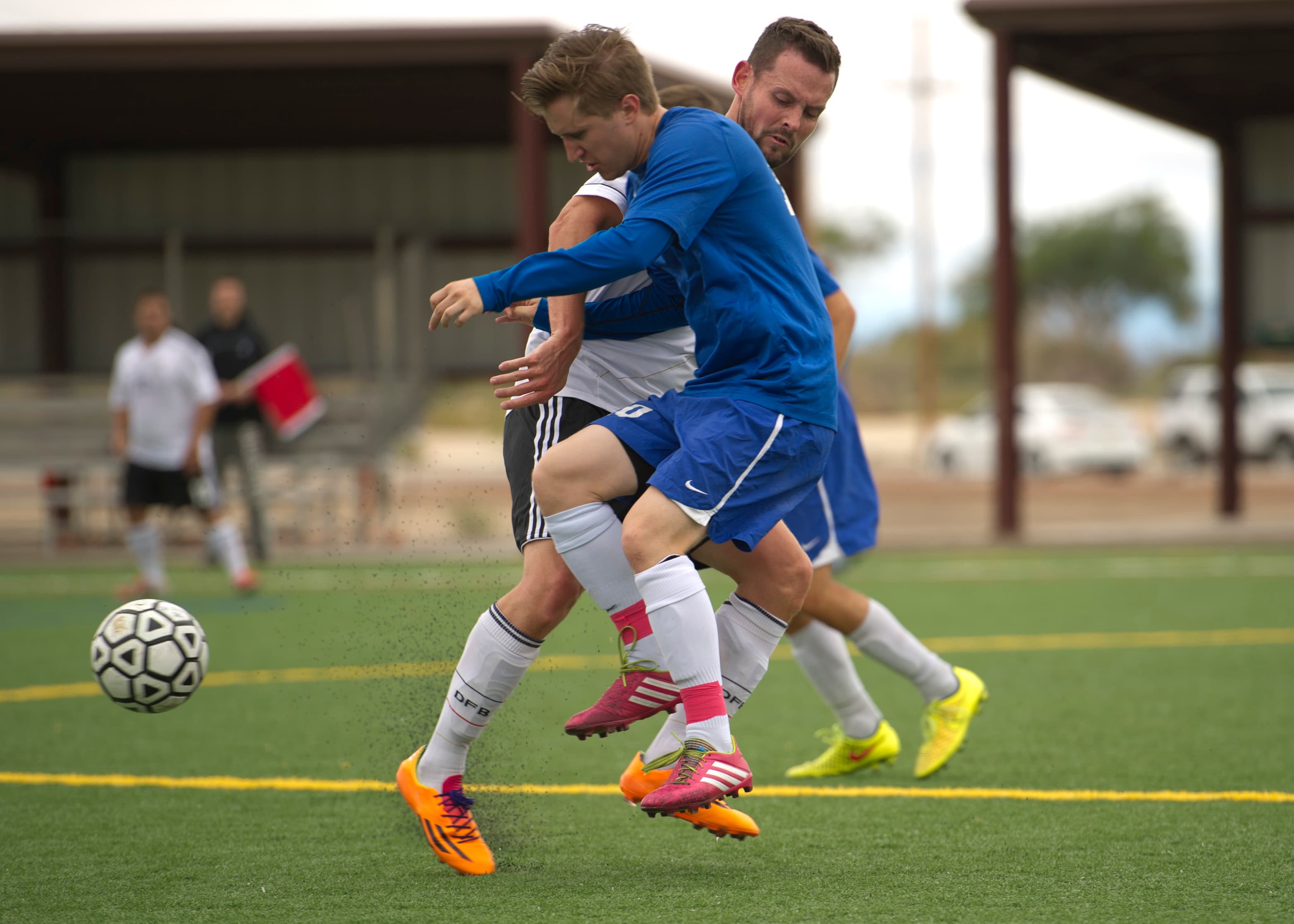 Soccer players battling for the ball on the pitch